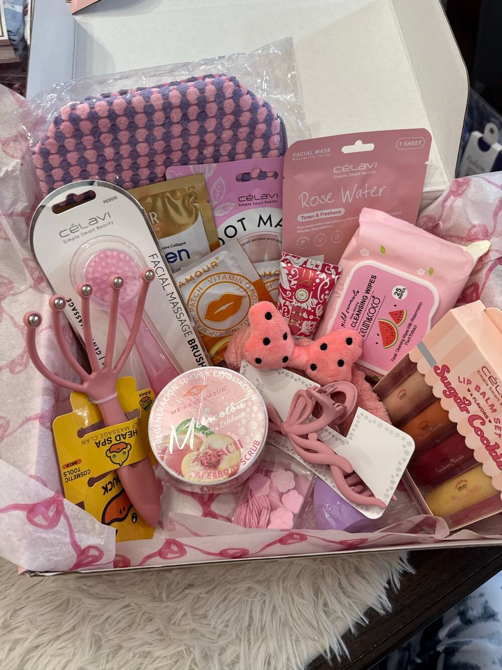 Pink spa gift basket with face masks, lip balms, and other beauty products